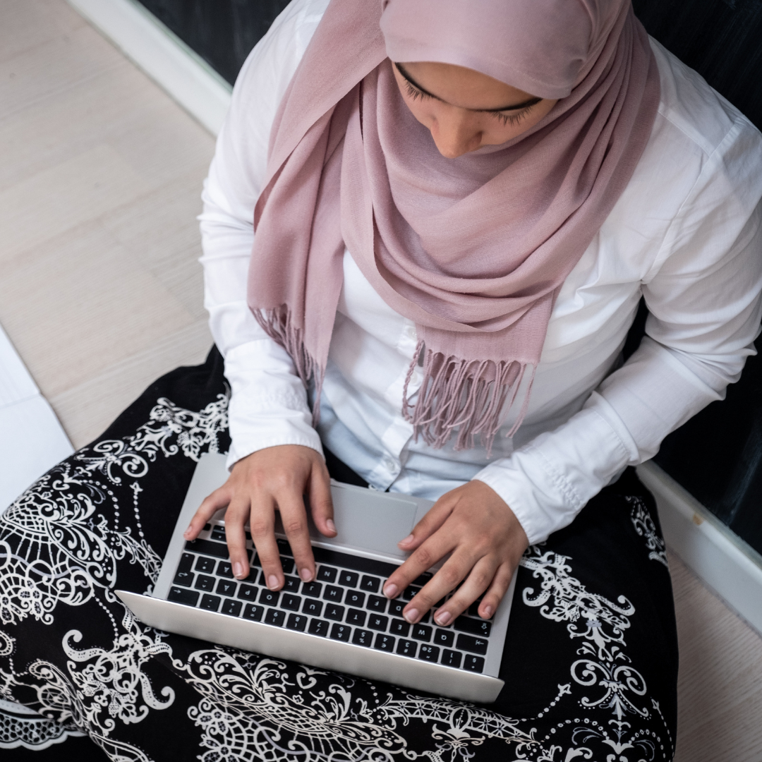 Woman with headscarf using a laptop